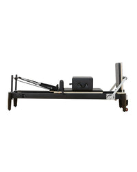 Aluminium Pilates Reformer by Gym Gear showing adjustable resistance springs and padded carriage for Pilates exercise.